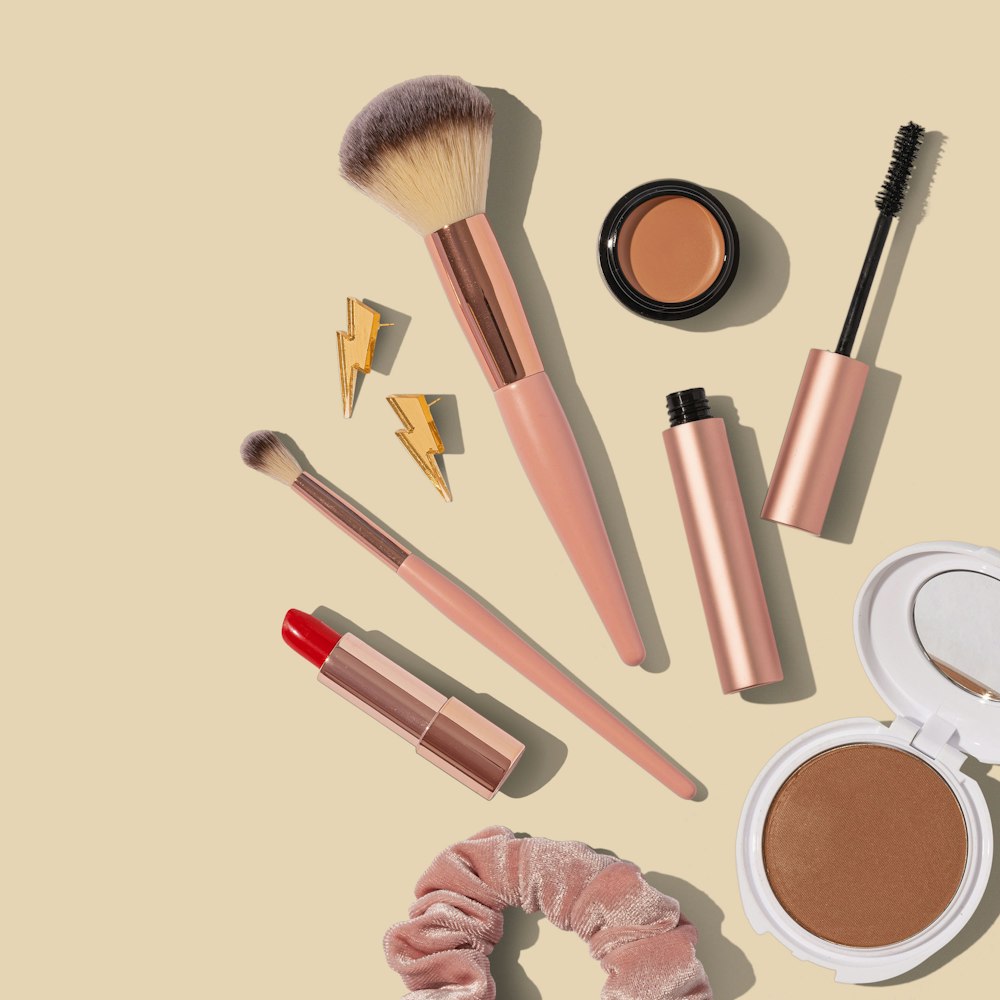 Warm-toned makeup flatlay with brushes